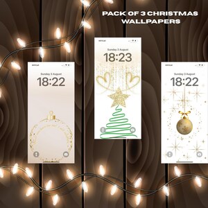 May include: Three Christmas-themed phone wallpapers displayed on a wooden background, with string lights. The wallpapers feature gold and green designs, including a Christmas tree, ornaments, and text. The top text reads "PACK OF 3 CHRISTMAS WALLPAPERS".