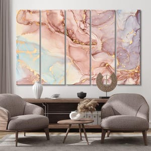 May include: Five-panel abstract art piece with a fluid design in shades of pink, gold, and blue. The artwork is displayed above a wooden cabinet, with two armchairs and a small table in front. The overall theme is modern home decor.