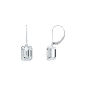 May include: A pair of silver drop earrings featuring emerald-cut, clear gemstones. The earrings have a lever-back closure and are set against a white background. The gemstones are rectangular with cut facets.