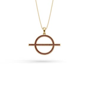 May include: A gold necklace featuring a circular pendant with a horizontal bar running through the center. The circular frame and the horizontal bar are both inlaid with small, deep red gemstones. The pendant hangs from a delicate gold chain.