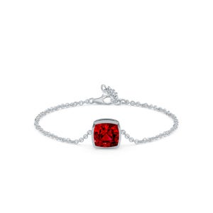 May include: A silver bracelet featuring a large, square-cut, vibrant red gemstone. The gemstone is set in a bezel setting and is the focal point of the delicate chain bracelet. The bracelet is designed with a lobster clasp.