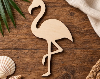 May include: A flat, light-colored wooden cutout in the shape of a flamingo standing on one leg. The silhouette features the characteristic long, curved neck, rounded body, and slender legs of the bird, presented as a simple, unpainted wooden form.
