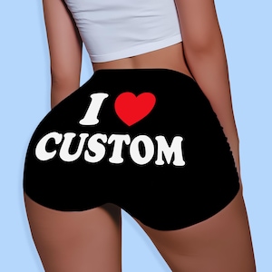 May include: Black shorts with the text "I ❤️ CUSTOM" in white and a red heart. The shorts are made of a soft material.