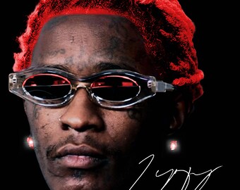 May include: Portrait of a person with red hair and clear-framed sunglasses with red lenses. The person has facial tattoos and is wearing red earrings. A white signature is in the bottom right corner against a black background.