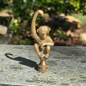 Antique brass monkey finial