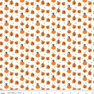 May include: Off-white fabric with a repeating pattern of orange jack-o'-lanterns and black cats. Small black stars are scattered throughout the design. The pumpkins have carved faces and are in various sizes. The fabric is marked with inches.