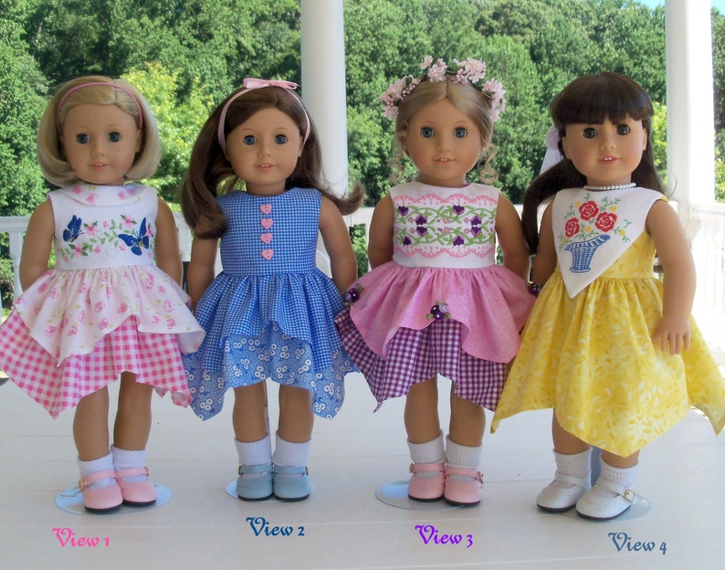 May include: Four dolls wearing different dresses. The doll on the left is wearing a pink and white dress with butterflies. The doll in the middle is wearing a blue and white gingham dress. The doll on the right is wearing a yellow dress with a floral design. The doll in the back is wearing a pink and purple dress with a floral design.
