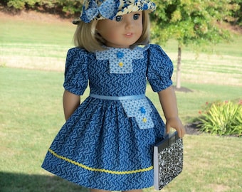 May include: A blue and yellow patterned dress with a white collar and a yellow trim. The dress has a pocket on the front and a matching hat with a blue bow. The doll is holding a black and white notebook. The text on the image reads "Farmcookies Original Designs Historical Sewing Patterns for 18" Dolls Design #23 Skill Level- Intermediate Kit, Star Reporter"