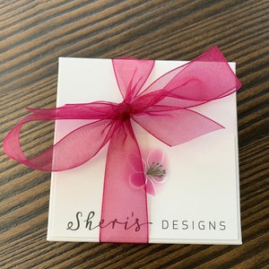 Classic white gift box with a pretty deep pink ribbon accompanies each ring or ring set.