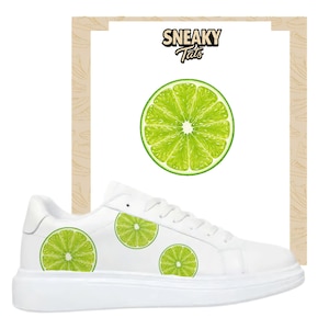 May include: White sneakers with lime slice graphics. The shoes feature a chunky sole and a clean, minimalist design. The image also includes a lime slice graphic and the text "Sneaky Tats".