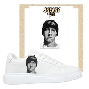 May include: White sneakers featuring a black and white portrait of a person wearing a beanie. The image is repeated on the side of the shoe. The word "Sneaky Tats" is printed above the portrait.