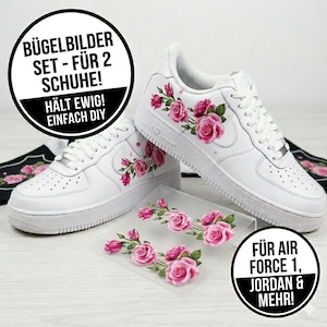 May include: White sneakers with pink rose decals. The shoes have a classic design with laces and a rubber sole. The image also shows a set of iron-on decals with rose designs and text that reads "FOR AIR FORCE 1, JORDAN & MORE!"