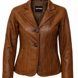 May include: A brown leather blazer with a classic design. The jacket features a notched collar, two-button closure, and a tailored fit. The label inside the jacket reads "EAGLE VOGUE".