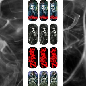 May include: A sheet of nail art featuring images of Rob Zombie. The designs include portraits of Rob Zombie, the text "ROB ZOMBIE" in red, and a cross design. The background has a smoky effect and the text "A Touch of Evil".