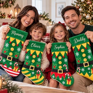 May include: Four green Christmas stockings featuring elf-themed designs with yellow buttons, black belts, candy canes, and white snowflakes. Each stocking is personalized with white embroidered names: Mommy, Oliver, Sophia, and Daddy.