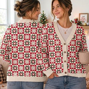 May include: A long-sleeve button-down cardigan featuring a repeating geometric star pattern in red, green, and white. The knit fabric includes small grey Mickey Mouse head silhouettes within the stars. It has a cream-colored ribbed V-neck collar.