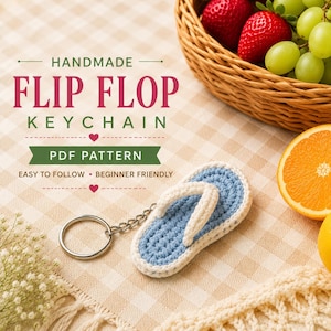 Könnte beinhalten: Ein handgefertigter Flip-Flop-Schlüsselanhänger aus Häkelarbeit mit hellblauer Sohle und cremefarbenem Riemen an einem silbernen Metallring. Der Text lautet: HANDMADE FLIP FLOP KEYCHAIN, PDF PATTERN, EASY TO FOLLOW, BEGINNER FRIENDLY, mit Herzsymbolen.