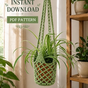 May include: A light green crocheted plant hanger holding a terracotta pot with a spider plant. The text INSTANT DOWNLOAD and PDF PATTERN is visible in the upper left corner. The hanger features a diamond-shaped net pattern and long straps.