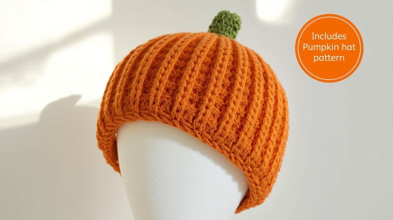 May include: An orange knitted pumpkin hat with a green stem, displayed on a white mannequin head. The hat has a ribbed texture. An orange circle with the text "Includes Pumpkin hat pattern" is in the image.