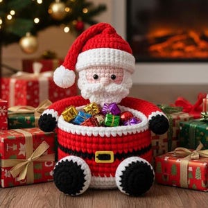 May include: A crocheted Santa Claus figure in a red suit and hat, holding a basket of wrapped gifts. The figure is surrounded by wrapped presents in various colours and patterns, creating a festive holiday scene.