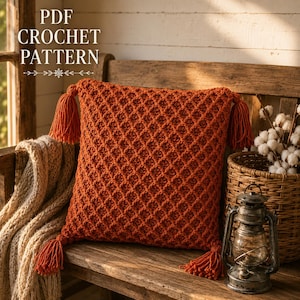 May include: A square, burnt orange crochet pillow cover featuring a textured diamond pattern and four matching corner tassels. The text PDF CROCHET PATTERN is visible in the upper left corner of the image, indicating a digital design document.