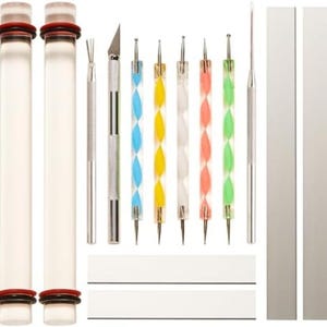 May include: A collection of craft tools, including clear cylindrical containers with red and black accents, various metal-handled tools, and tools with colorful, twisted handles. Also included are white and silver rectangular tools.