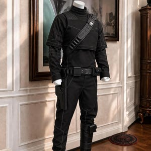 May include: A black tactical outfit on a mannequin, featuring a long-sleeved mock neck shirt with white contrast stitching, a layered vest, a utility belt with a holster, matching black trousers, and tall black boots with straps and a small pouch.