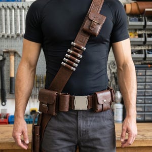 Mandalorian-inspired leather utility belt featuring a detailed leg holster design for bounty hunter cosplay and Star Wars costume builds. This handmade cosplay belt includes durable leather construction, adjustable fit, and screen-inspired styling suitable for Mandalorian costumes, Din Djarin cosplay, Comic Con, Halloween, and fan conventions. The leather belt and leg holster accessory is ideal for completing bounty hunter outfits, cosplay photography, collector displays