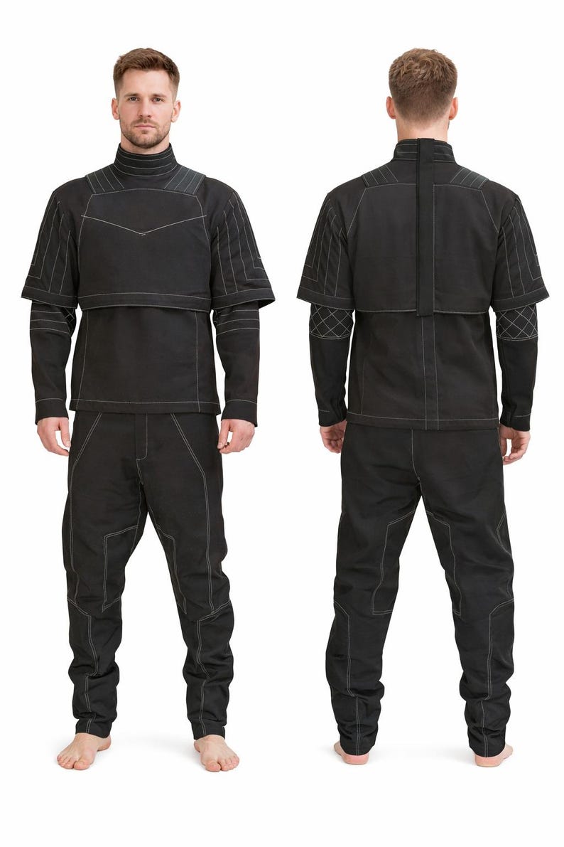 May include: A black two-piece outfit consisting of a long-sleeved top and matching pants. The top features a high collar, a layered chest panel, and white contrast stitching. The pants have a relaxed fit with white stitched seam detailing.