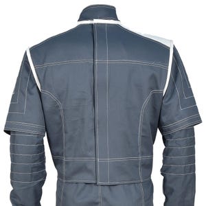 May include: A gray jumpsuit with white trim and stitching. The back view shows a high collar, shoulder accents, and detailed stitching patterns. The jumpsuit has short sleeves and a tailored fit, suitable for various activities.