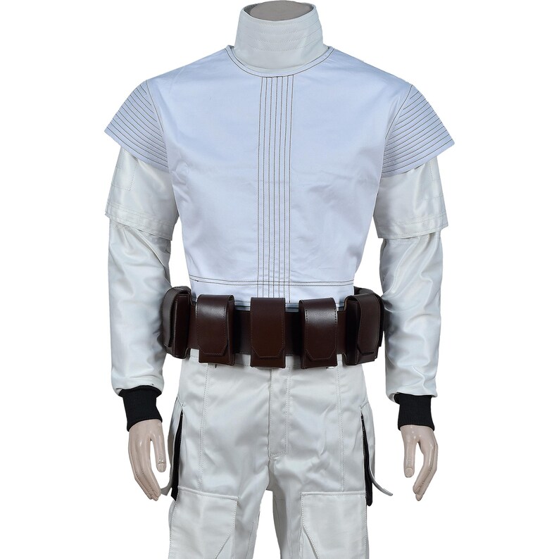 May include: White costume with a high collar, long sleeves, and a brown belt with pouches. The top has vertical stitching and short sleeves. The pants are white with a side pocket. Black cuffs are visible at the wrists.