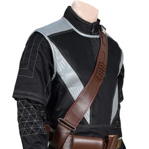 May include: Black and gray tactical jacket with a brown leather shoulder strap and belt. The jacket features silver accents and white stitching details. The outfit is designed with a futuristic aesthetic.