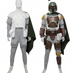 May include: Two complete Star Wars costumes are displayed. One is a white and gray outfit with a dark green cape. The other is a Boba Fett costume, featuring a helmet, armor, and various accessories in shades of green, brown, and gray. Both costumes are on mannequins.