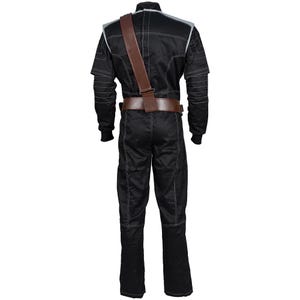 May include: Black jumpsuit with white stitching details, a brown leather belt, and a matching shoulder strap. The suit has silver accents on the shoulders and sleeves. The overall design suggests a costume or uniform.