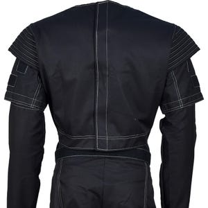 May include: Black jacket with white stitching details. The jacket features a unique design with layered shoulder accents and a fitted waist. The sleeves are long, and the back of the jacket is visible, showcasing the stitching.