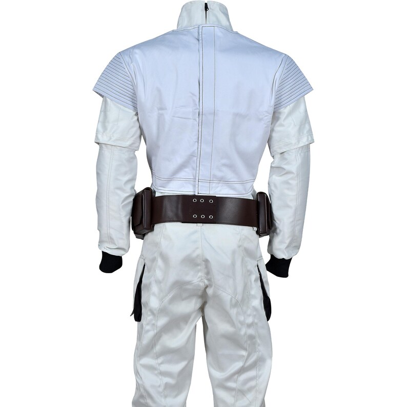 May include: A white jumpsuit with a high collar and a brown belt with two pouches. The back of the jacket has a structured design with horizontal lines on the shoulders. Black cuffs are visible at the wrists.