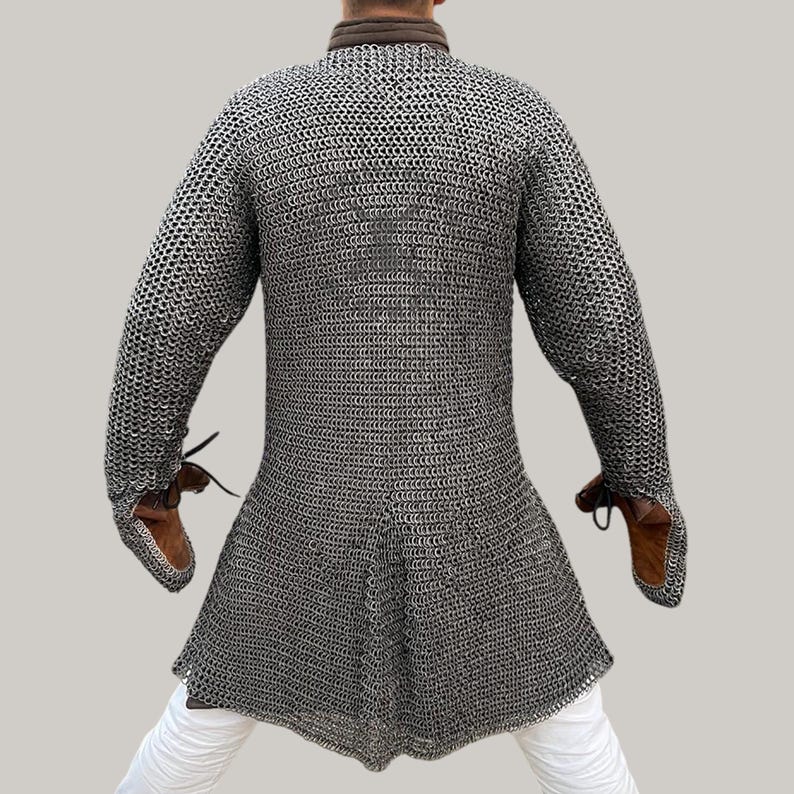 Model wearing aluminium chainmail hauberk with gloves at Renaissance fair, medieval cosplay armor