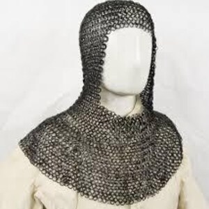 May include: A chainmail coif, a type of medieval head and neck protection, is displayed on a mannequin. The coif is constructed of small, interlocking metal rings, providing flexible yet robust defense. The coif is dark gray and covers the head, neck, and shoulders.