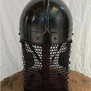 May include: A black metal helmet with a rounded top and a chainmail face guard. The helmet has a dark, reflective surface and is riveted at the base. The chainmail is made of small, interlocking rings.