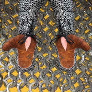 Side view of chainmail hauberk showing length and sleeve fit for medieval reenactment costume