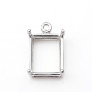 May include: A silver-colored, rectangular pendant setting with a loop at the top for a chain. The setting has four small prongs at each corner to hold a stone or other embellishment. The pendant is designed to be used for jewelry making.