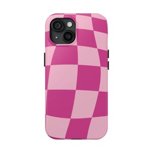 May include: Pink and light pink checkered phone case with a black camera bump.