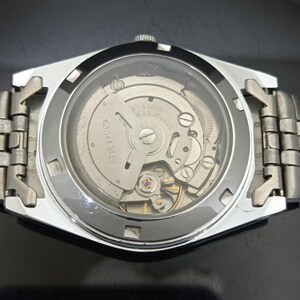 May include: A silver-toned wristwatch with an exhibition case back revealing the internal mechanical movement. The rotor is engraved with the text SEIKO, 6309A, and 17 JEWELS. The watch features a metallic link bracelet and a circular glass window.