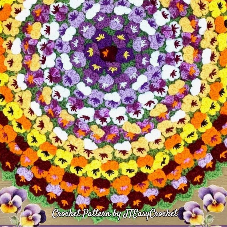 A colorful, circular crochet pattern featuring a floral design. The pattern showcases a vibrant array of colors, including yellow, orange, purple, and white, arranged in concentric circles. The text "Crochet Pattern by JTEasyCrochet" is visible at the bottom.