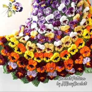 A colorful crochet blanket featuring a pattern of pansy flowers in shades of purple, yellow, orange, and white. The blanket is made of colorful pansy flowers arranged in circular pattern and the fringe of the blanket is made of green pansy leaves. The lettering says: "Pansy Flower Blanket", "Crochet Pattern By JTEasyCrochet" meaning that JTEasyCrochet has the best crochet patterns and fun crochet ideas.