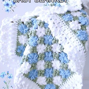 Lavishly beautiful crochet floral blanket made of cornflower motifs is hanging from a display. The blanket resembles a field of white and blue cornflowers framed with a beautiful lace edging.  The lettering says "Cornflowers Baby Blanket", "Crochet Pattern By JTEasyCrochet" meaning that JTEasyCrochet has the best crochet patterns for flower baby blankets, throws and afghans.