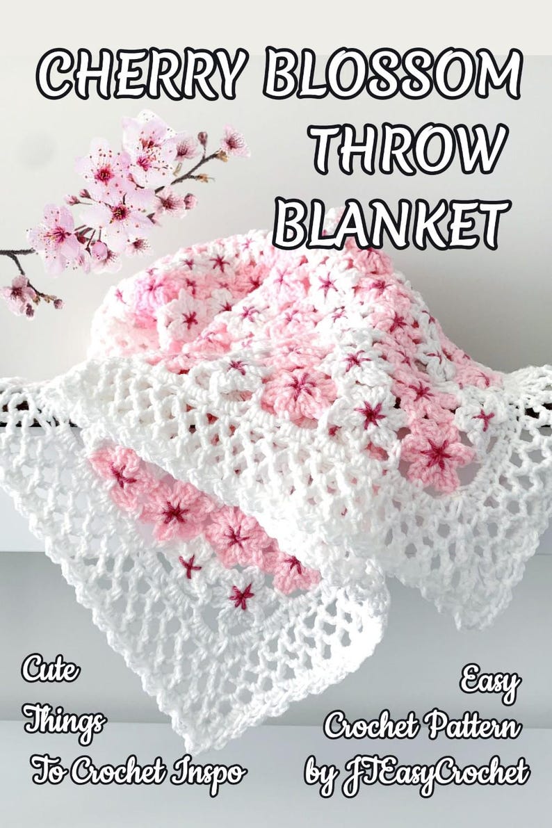 May include: A handmade crochet throw blanket with a cherry blossom design. The blanket features white and pink yarn, with cherry blossom accents. The text "CHERRY BLOSSOM THROW BLANKET" is at the top of the image, with additional text at the bottom.