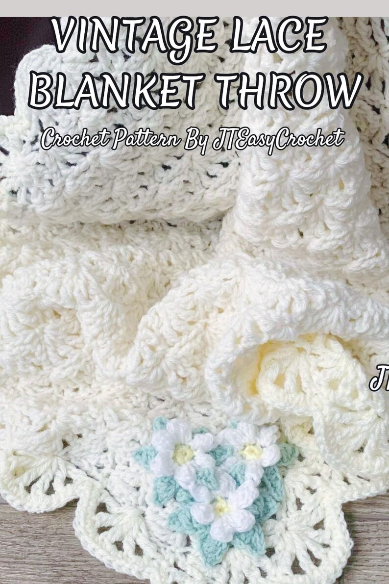 Beautiful lacy crochet blanket is laying tossed on a wooden surface. The blanket is crocheted with cream soft yarn and is airy and textured with the scalloped border giving it a vintage cottagecore vibe. There is a crochet flower applique in the corner of the blanket - three puffy white  daisies framed with pale green leaves. The lettering says: "Vintage Blanket Throw", "Crochet Pattern By JTEasyCrochet".