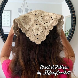 May include: A cream and beige crochet headscarf featuring a floral design. The headscarf is made from yarn and has a scalloped edge. The image includes the text "Crochet Pattern by JTEasyCrochet".