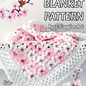 May include: A crochet throw blanket pattern with a floral design in white and pink. The blanket features a repeating flower pattern and is displayed with cherry blossom branches. Text on the image reads "CROCHET THROW BLANKET PATTERN by JEasyCrochet."